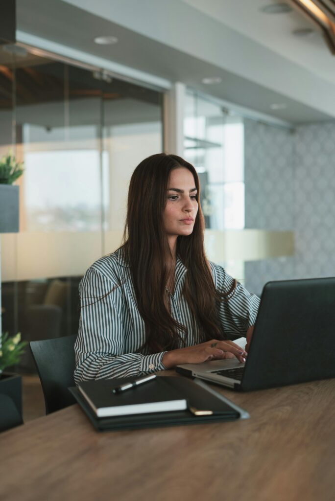 pexels photo 10041233 10041233 Focused businesswoman typing on laptop in a stylish, modern office setting.
