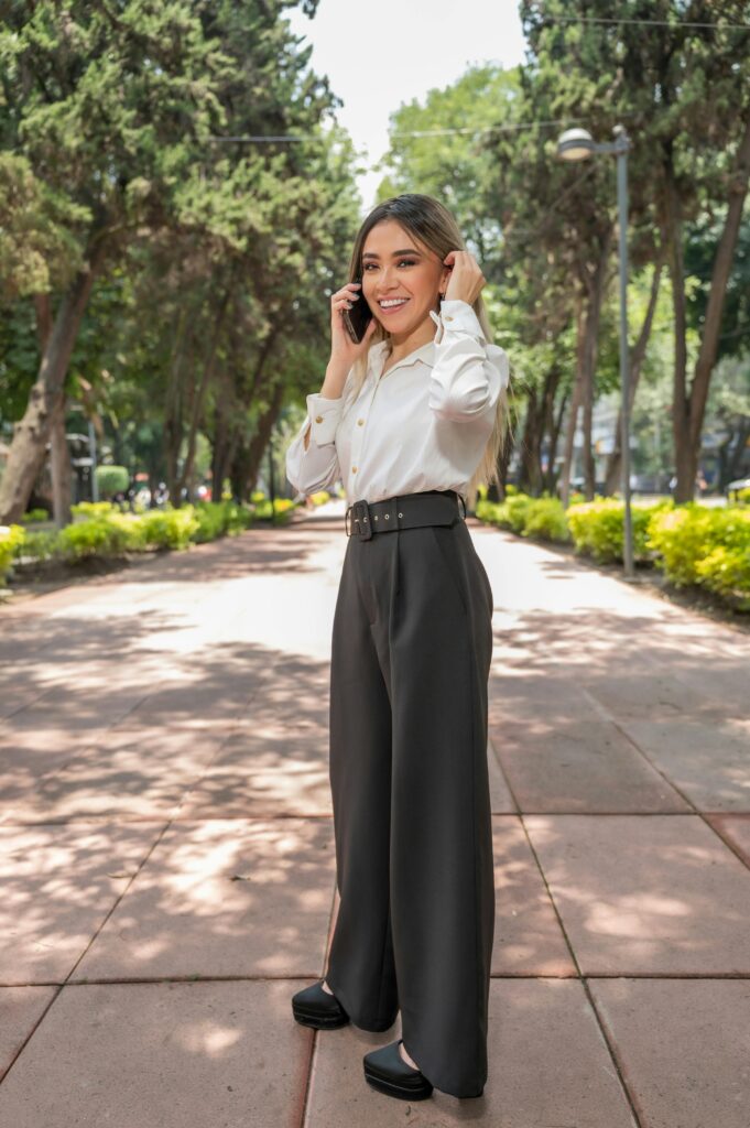 pexels photo 28386385 28386385 Elegant woman in business attire talking on the phone in a serene park setting in Ciudad de México.