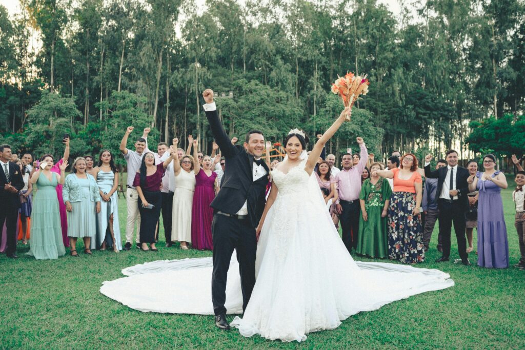 pexels photo 32995149 32995149 Bride and groom celebrate with guests outdoors in a vibrant summer wedding ceremony.