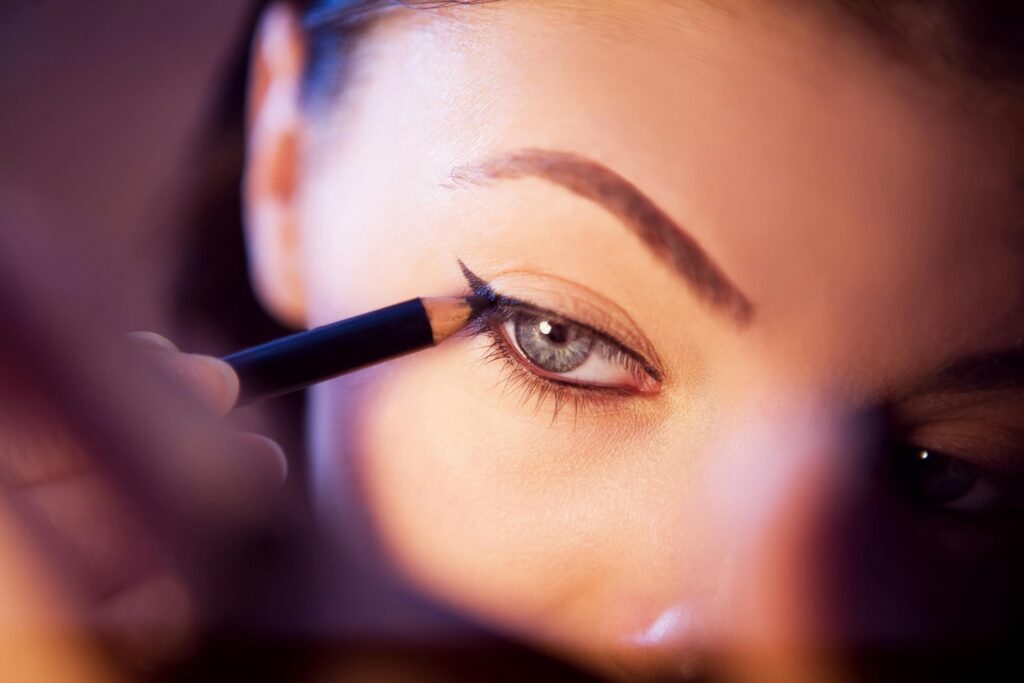 pexels photo 6713323 6713323 A close-up shot of a woman applying eyeliner with precision.